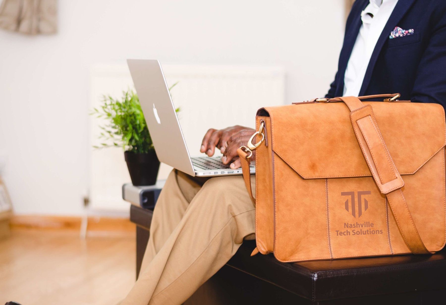 Imprinted Bags, Swag, and Promotional Products for Nashville, Tennessee brown leather imprinted tote on a bench. printed with Nasville Tech Solutions logo